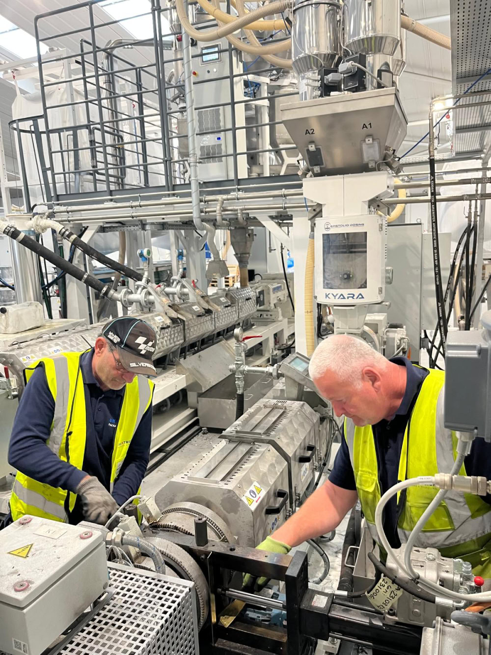 2 service engineers working on extrusion equipment