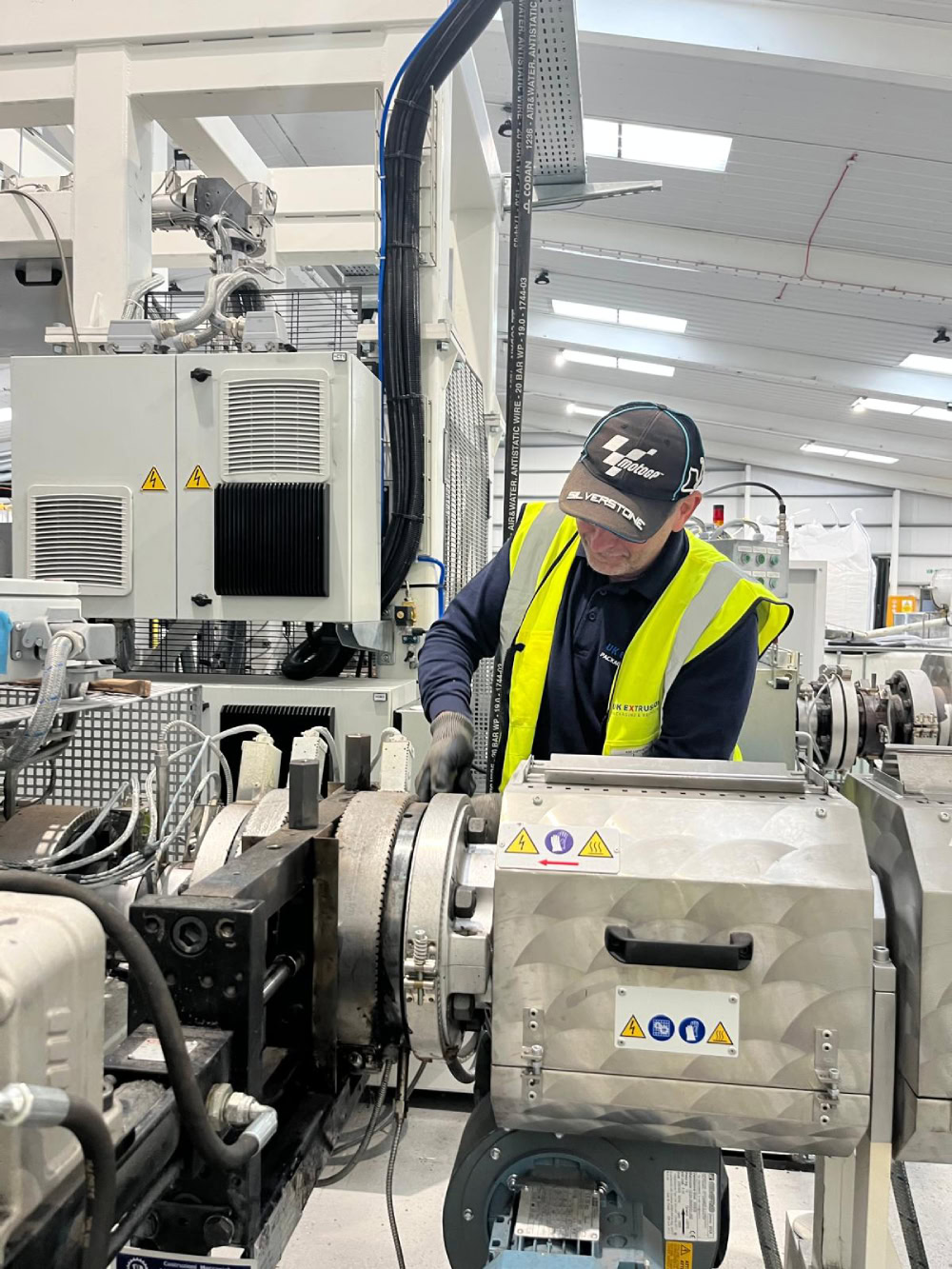 Service engineer working on extrusion equipment