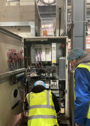People repairing extrusion equipment
