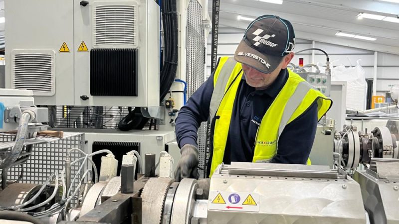 Service engineer working on extrusion equipment